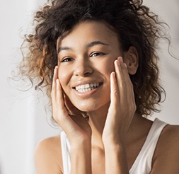 Woman sharing smile after dental office visit