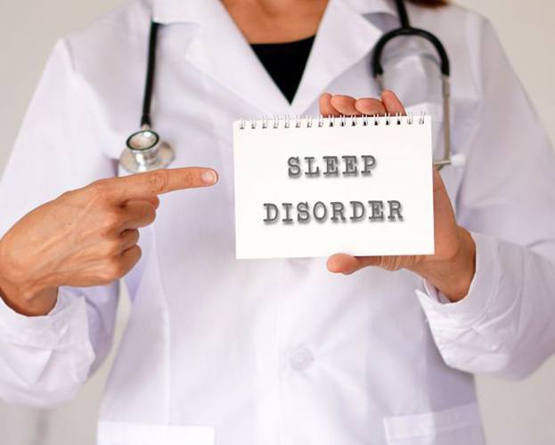 Doctor holding sign that reads “sleep disorder”