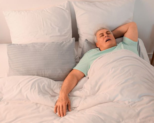 Senior man snoring in bed
