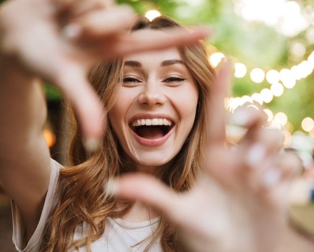 Woman showing off smile after visiting her dentist