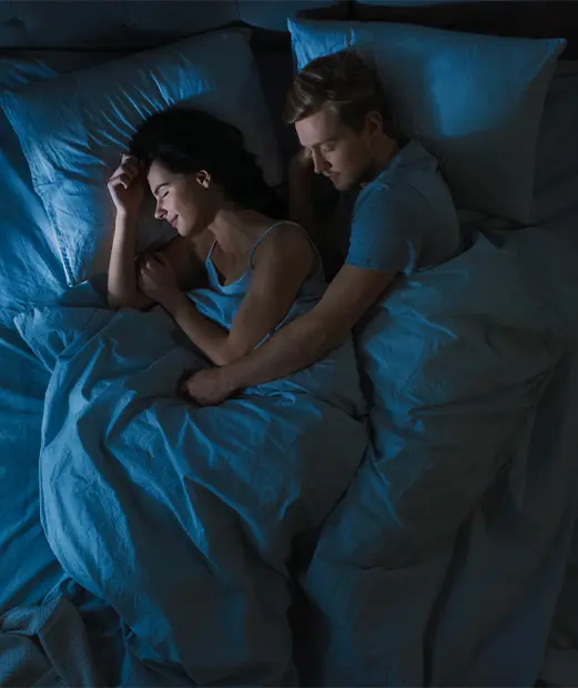 Couple sleeping peacefully in bed