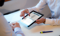 Patient reviewing dental insurance forms on tablet