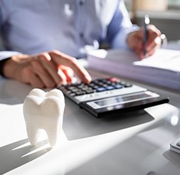 Person calculating dental insurance coverage