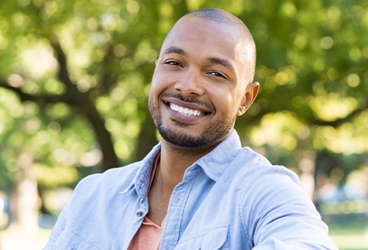 Man with healthy smile after advanced dental services and technology