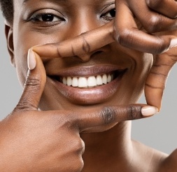 Woman showing off healthy smile after gum disese treatment