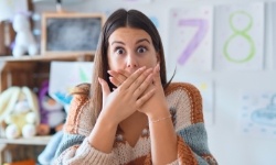 Woman with knocked out tooth covering her mouth