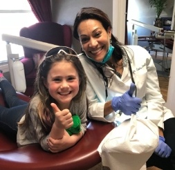 Doctor Castillo and young patient smiling together
