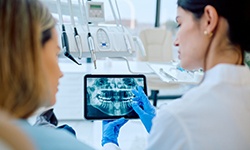 Dentist and patient looking at X-ray together
