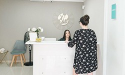 Dental team member assisting patient at front desk