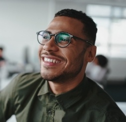 Man smiling after dental implant tooth replacement