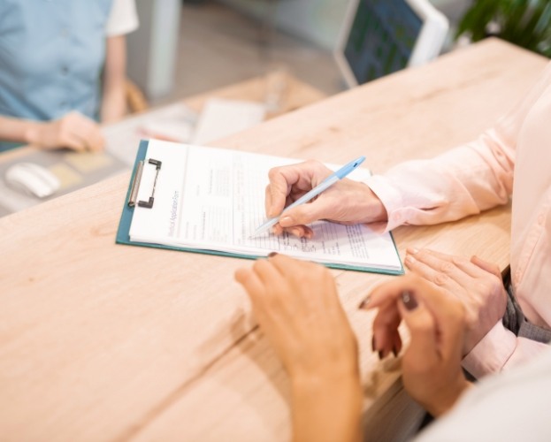 Patient completing dental insurance forms