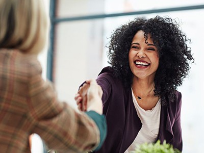 Woman shaking hands in a professional setting
