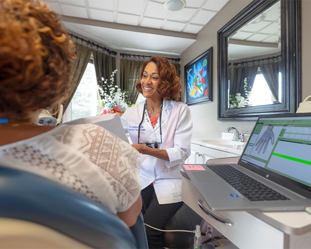 Dr. Castillo speaking with patients while using the BioScanMSA Ivory device