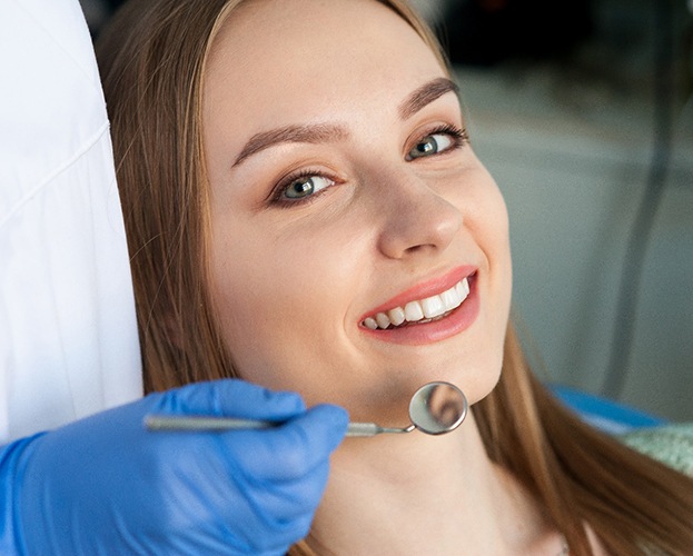 Patient smiling during appointment with holistic dentist in North Providence