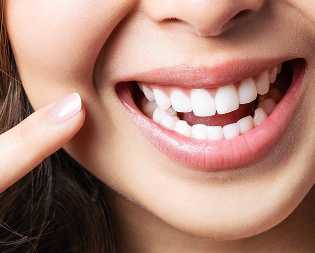 Woman pointing at healthy smile after ozone therapy treatment