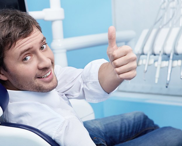 Handsome male patient giving thumbs up for ozone therapy