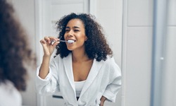 Woman brushing teeth in North Providence