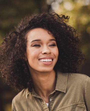 Woman smiling after periodontal disease treatment