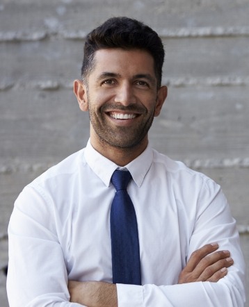 Man with flawless smile after replacing missing teeth