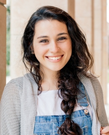 Young woman with perfected smile after orthodontic treatment