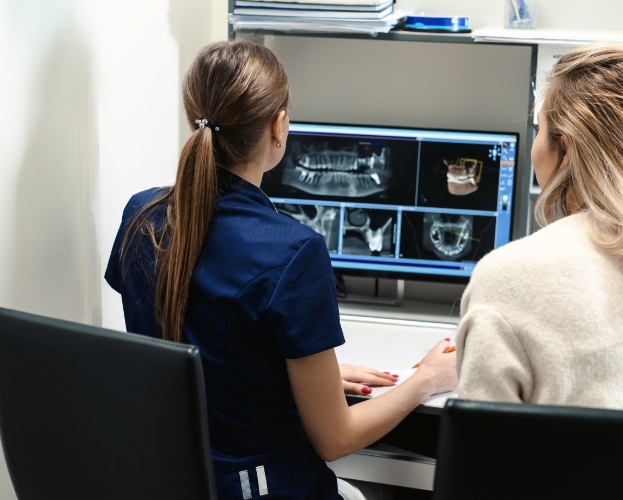 Dental team member reviewing digital x-rays