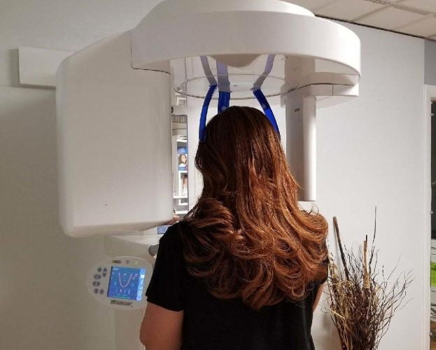 Woman receiving 3 D cone beam imaging scans
