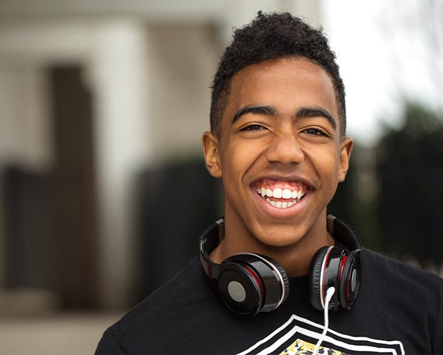 Young man with healthy smile after wisdom tooth extraction