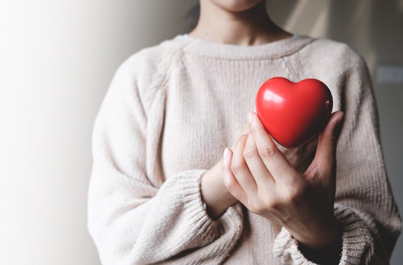 woman holding a cartoon heart