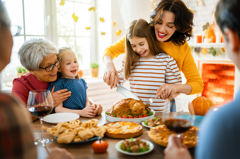 Patient smiling with family at Thanksgiving with dental implants