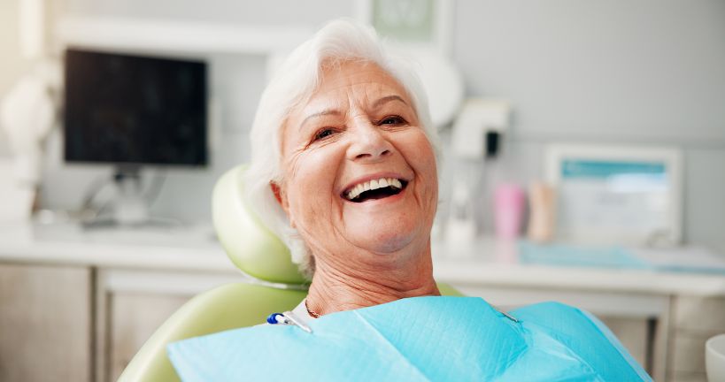 A smiling woman in a dental chair